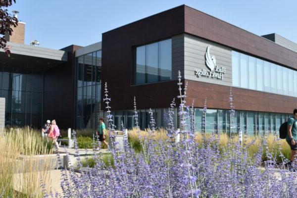 a building with purple flowers in front of it